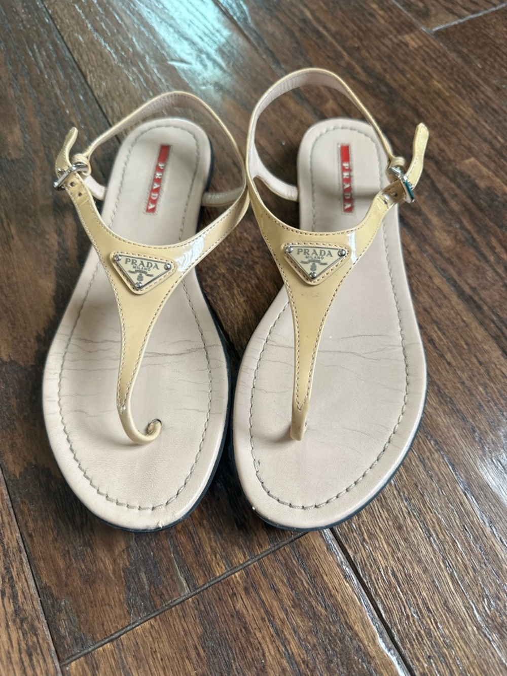 Prada Nude Patent Leather T-Strap Sandals with Gold Logo